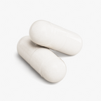 Close-up of two glossy white Magnesium Glycinate capsules resting side by side by nutrima.