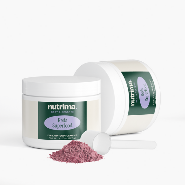 Reds Superfood powder in a jar with a scoop and spilled powder, showcasing its pink color and packaging by nutrima.