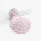 A transparent scoop overflowing with light pink Energy Powder (Guava Berry) resting on a white surface by nutrima.