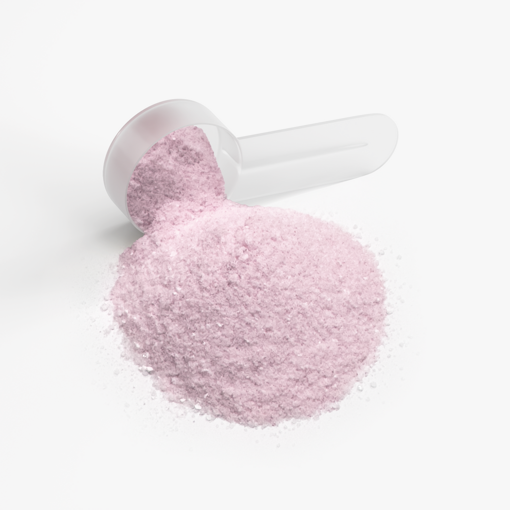 Pink hydration powder sits in a scoop, showcasing its fine texture and color for Intra-Workout Supplements by nutrima.
