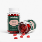 Clear bottle of red Hair, Skin & Nails Gummies with some gummies spilled, showcasing the product by nutrima.