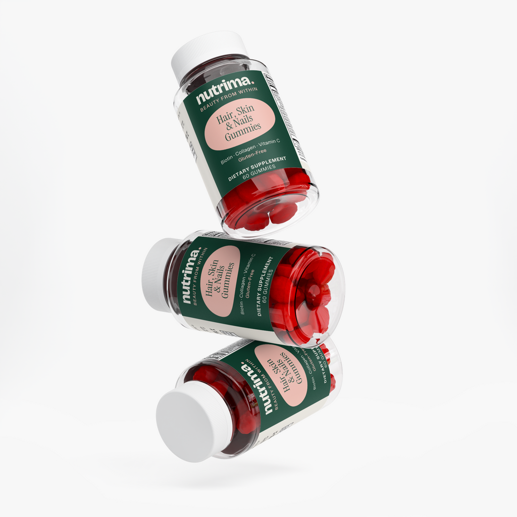 Three floating bottles of Hair, Skin & Nails Gummies featuring bright red gummies, by nutrima.