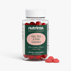 Close-up of Nutrimax Hair, Skin & Nails Gummies in a clear bottle, featuring red gummies and a vibrant label by nutrima.