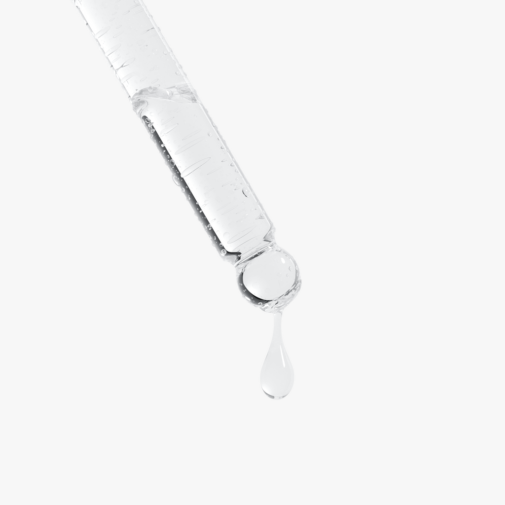 A clear dropper with a droplet of serum suspended, showcasing the PDRN Brightening Serum by nutrima.