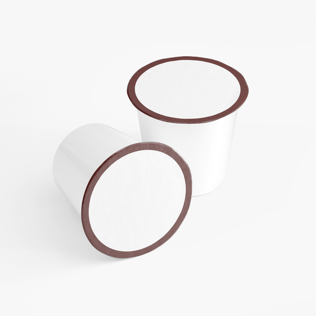 Two white Fruity Bloom Coffee Pods with brown lids, showcasing their round shape and light roast design, by nutrima.
