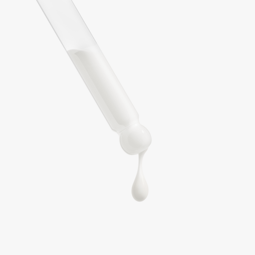 A drop of Retinol and Peptide Face Serum drips from a clear pipette, highlighting its smooth, creamy texture by nutrima.