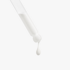 A drop of Retinol and Peptide Face Serum drips from a clear pipette, highlighting its smooth, creamy texture by nutrima.