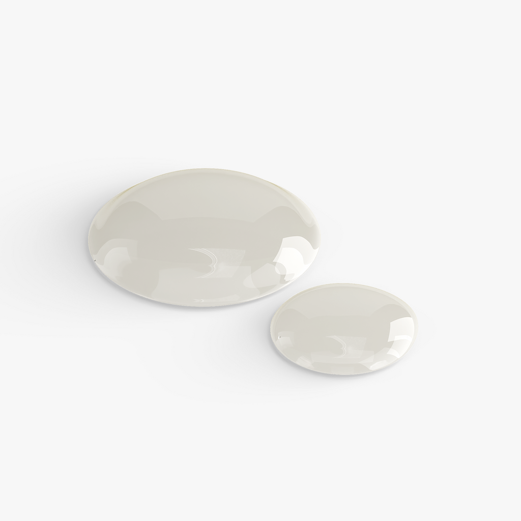 Two smooth, oval-shaped Gua Sha tools in a soft cream color, showcasing their glossy finish, by nutrima.