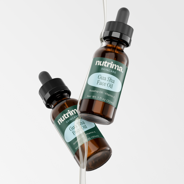 Two bottles of Gua Sha Face Oil with droppers, showcasing the rich amber color and brand label by nutrima.