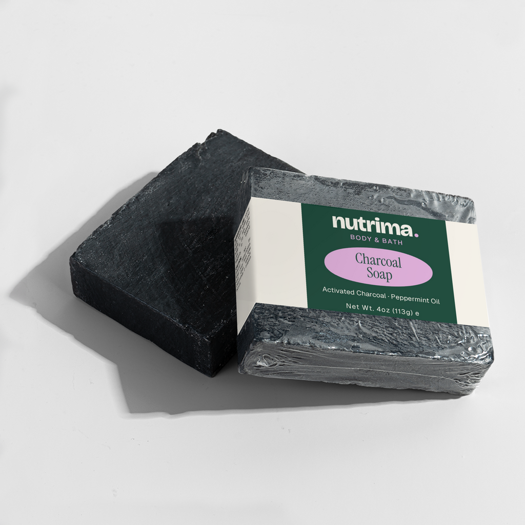 Black rectangular Charcoal Soap by nutrima, featuring a clear label with product details, on a light background.