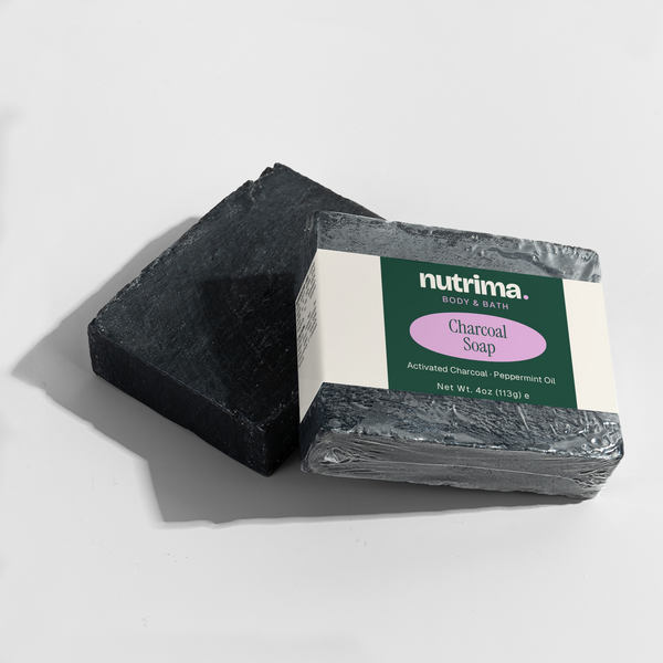 Black rectangular Charcoal Soap by nutrima, featuring a clear label with product details, on a light background.
