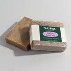 Two bars of Oat Milk Honey Soap showcasing a textured surface and packaging by nutrima.