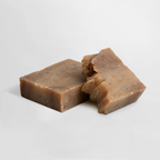 Two pieces of Oat Milk Honey Soap with a textured surface, showcasing its natural brown color and unique shape by nutrima.