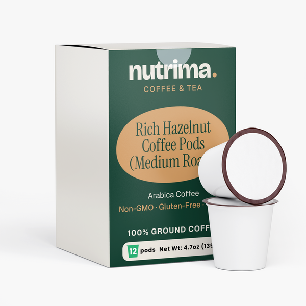 Rich Hazelnut Coffee Pods (Medium Roast) in a green box with two white pods, showcasing 100% ground Arabica coffee by nutrima