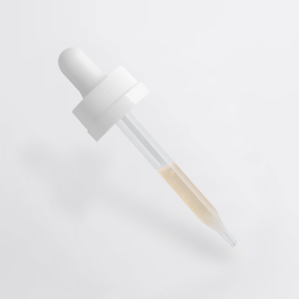 Close-up of a pipette with light serum, showcasing the Dark Spot Serum for Normal Skin by nutrima.