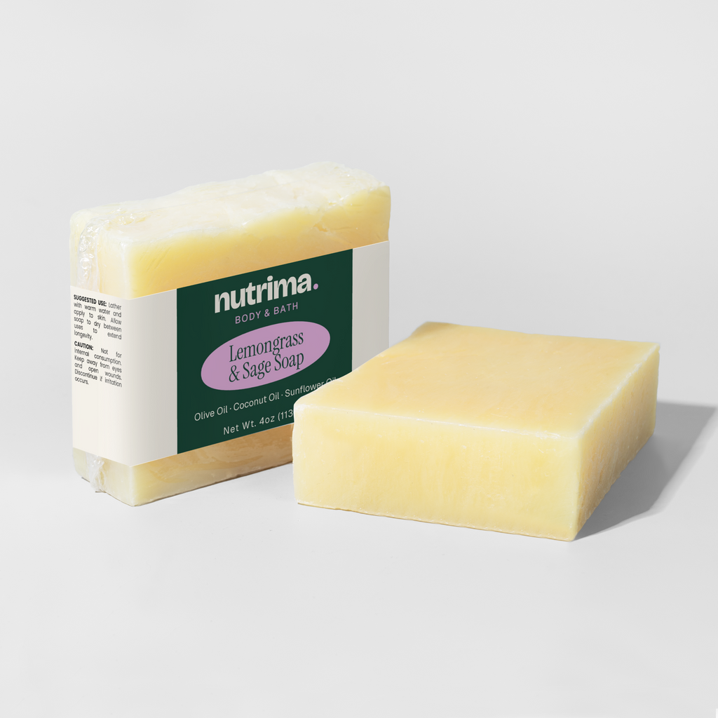 Lemongrass & Sage Soap, wrapped in clear film, showcases a creamy yellow block sitting beside its packaging by nutrima.