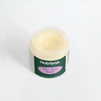 Open jar of creamy Raw Shea Butter showcasing its smooth texture and labeled packaging by nutrima.