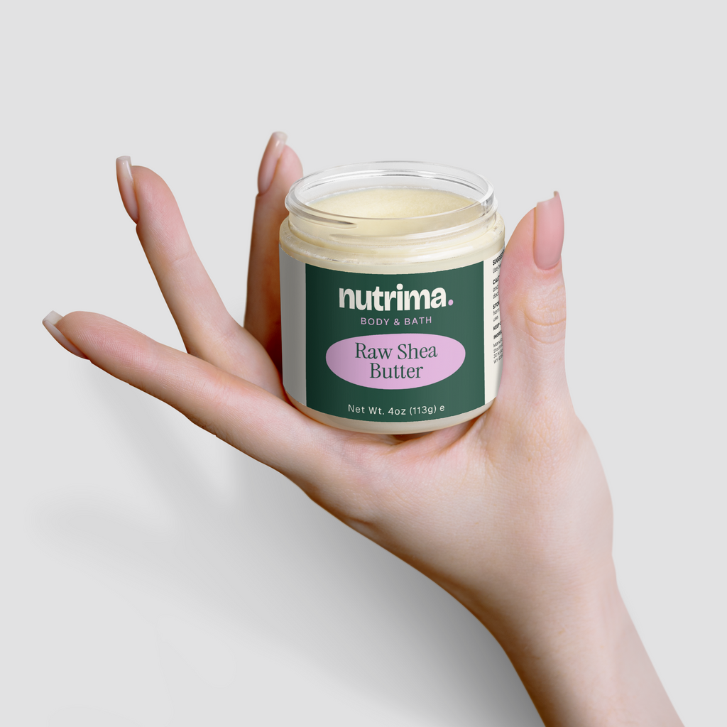 A hand holds a jar of creamy Raw Shea Butter showcasing a sleek design and vibrant label by nutrima.