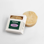 Exfoliating Luffa Bar next to its packaging, showcasing its natural texture and ingredients by nutrima.