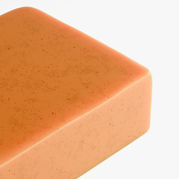 Close-up of a golden-orange Kojic Acid & Turmeric Soap showcasing its smooth texture and distinct speckled appearance by nutr