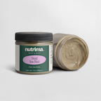 Lid off jar of Dead Sea Mud showing creamy texture, with packaging design visible, by nutrima.