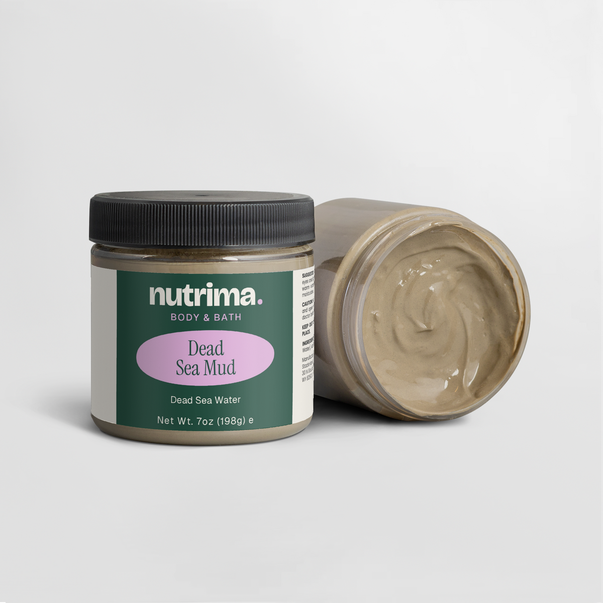 Lid off jar of Dead Sea Mud showing creamy texture, with packaging design visible, by nutrima.