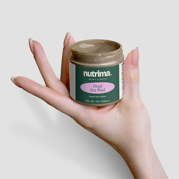 A hand holds a jar of Dead Sea Mud by nutrima, showcasing its unique packaging and earthy tone.