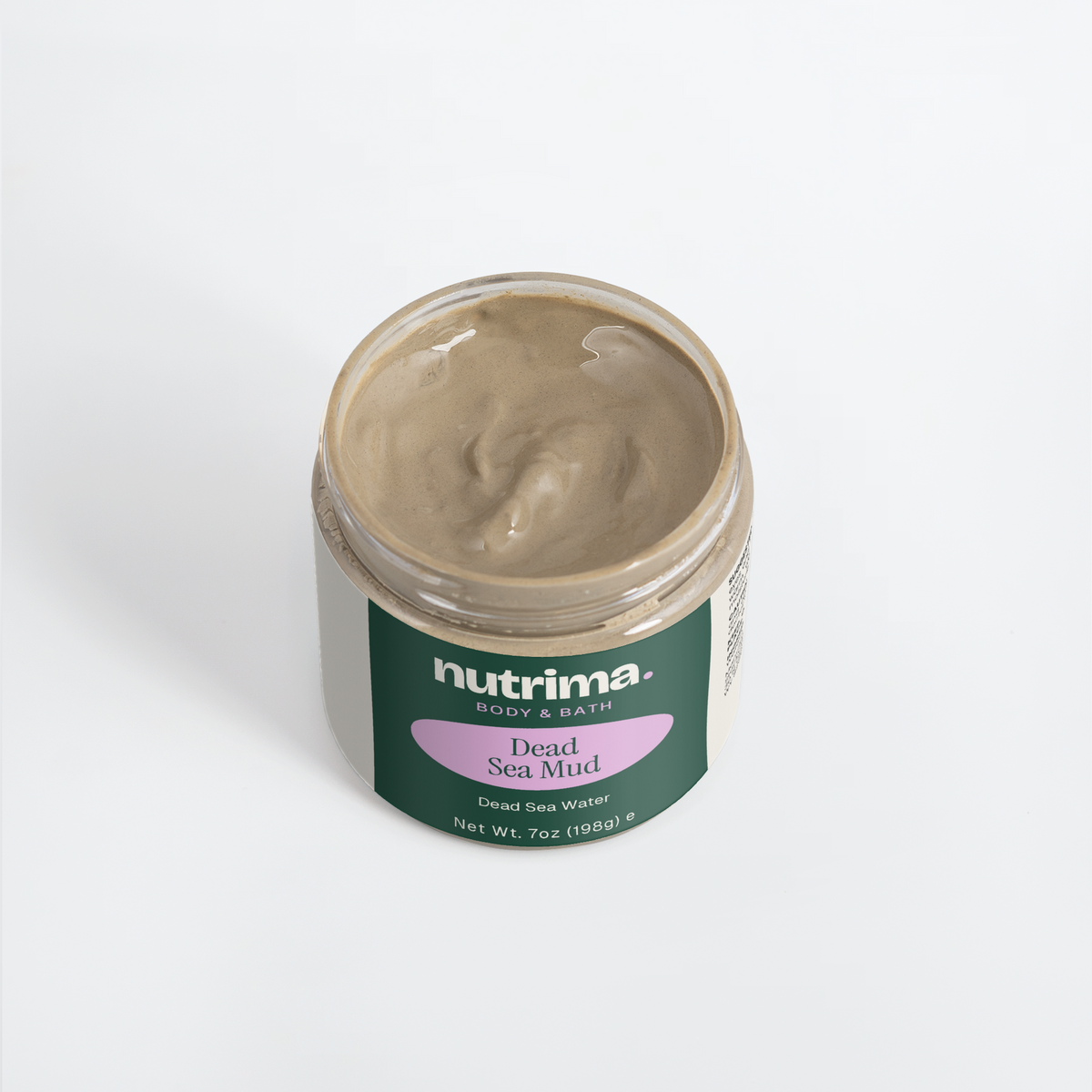Top view of a jar of Dead Sea Mud with creamy texture and bold green and purple packaging by nutrima.