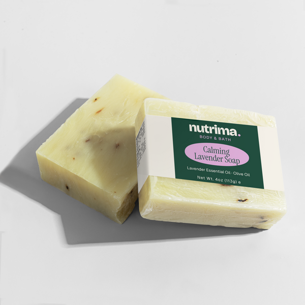 Two bars of Calming Lavender Soap with visible lavender specks, featuring packaging by nutrima.