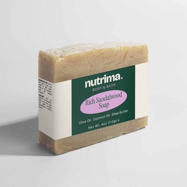 Close-up of Rich Sandalwood Soap by nutrima, showcasing its creamy texture and distinctive green and pink packaging.