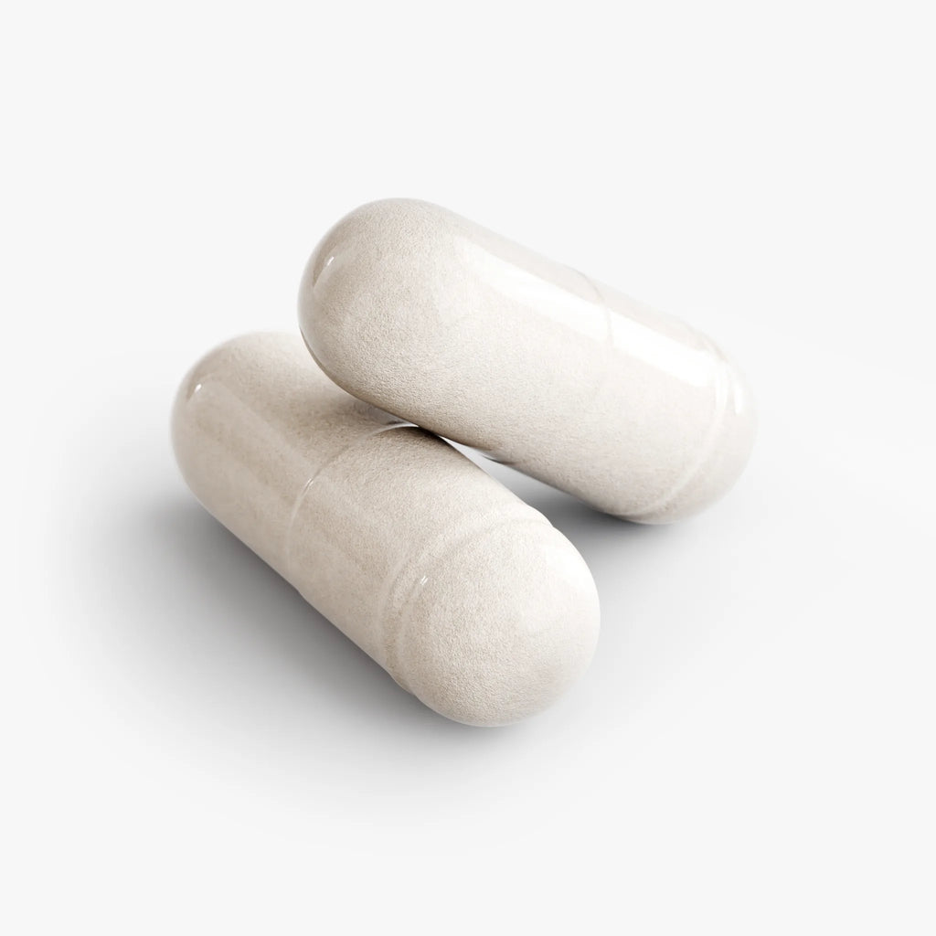 Two smooth, beige 5-HTP capsules stacked on a white background, highlighting their glossy finish. by nutrima.