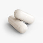 Two smooth, beige 5-HTP capsules stacked on a white background, highlighting their glossy finish. by nutrima.