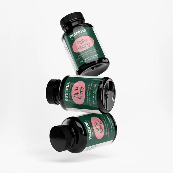 Three jars of Alpha Energy dietary capsules in a playful arrangement, showcasing their distinctive packaging by nutrima.