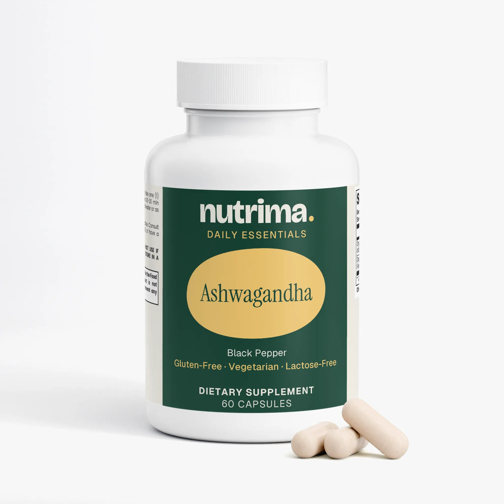 Angled view of a white bottle of Ashwagandha capsules with a green label and three capsules beside it by nutrima.