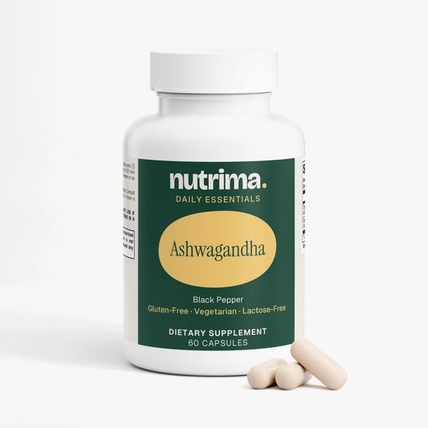 Angled view of a white bottle of Ashwagandha capsules with a green label and three capsules beside it by nutrima.