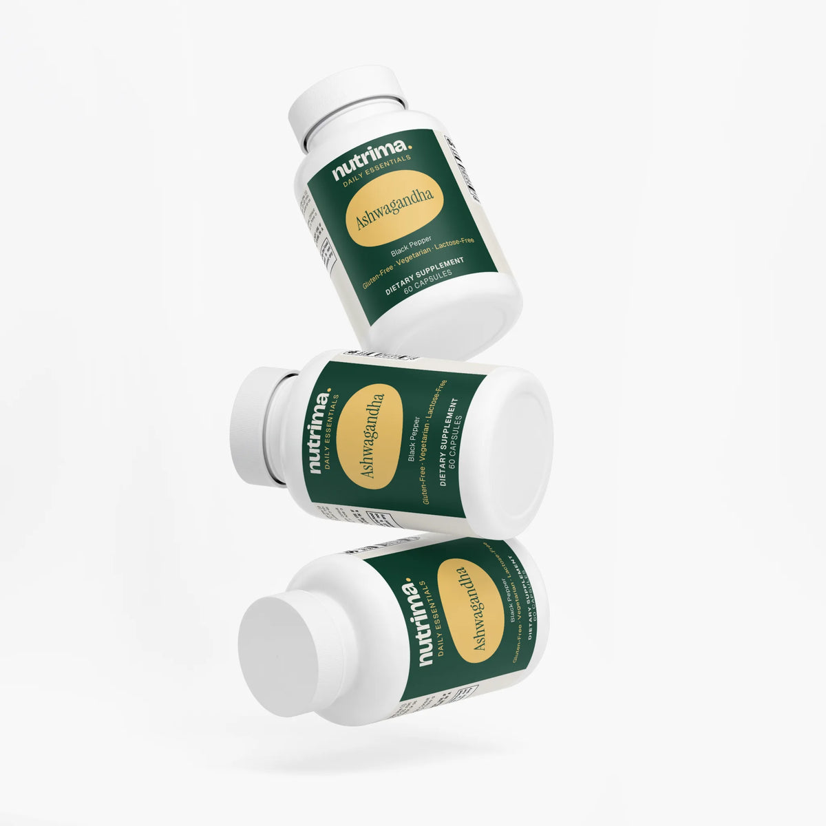 Three bottles of Ashwagandha are stacked at angles, showcasing the green and white packaging by nutrima.