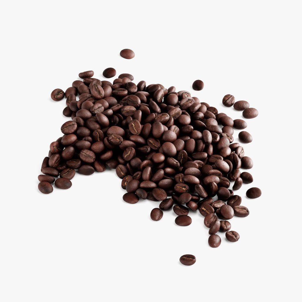 Medium roast Cherry Zest Coffee beans spill across a clean surface, showcasing their rich, dark color by nutrima.
