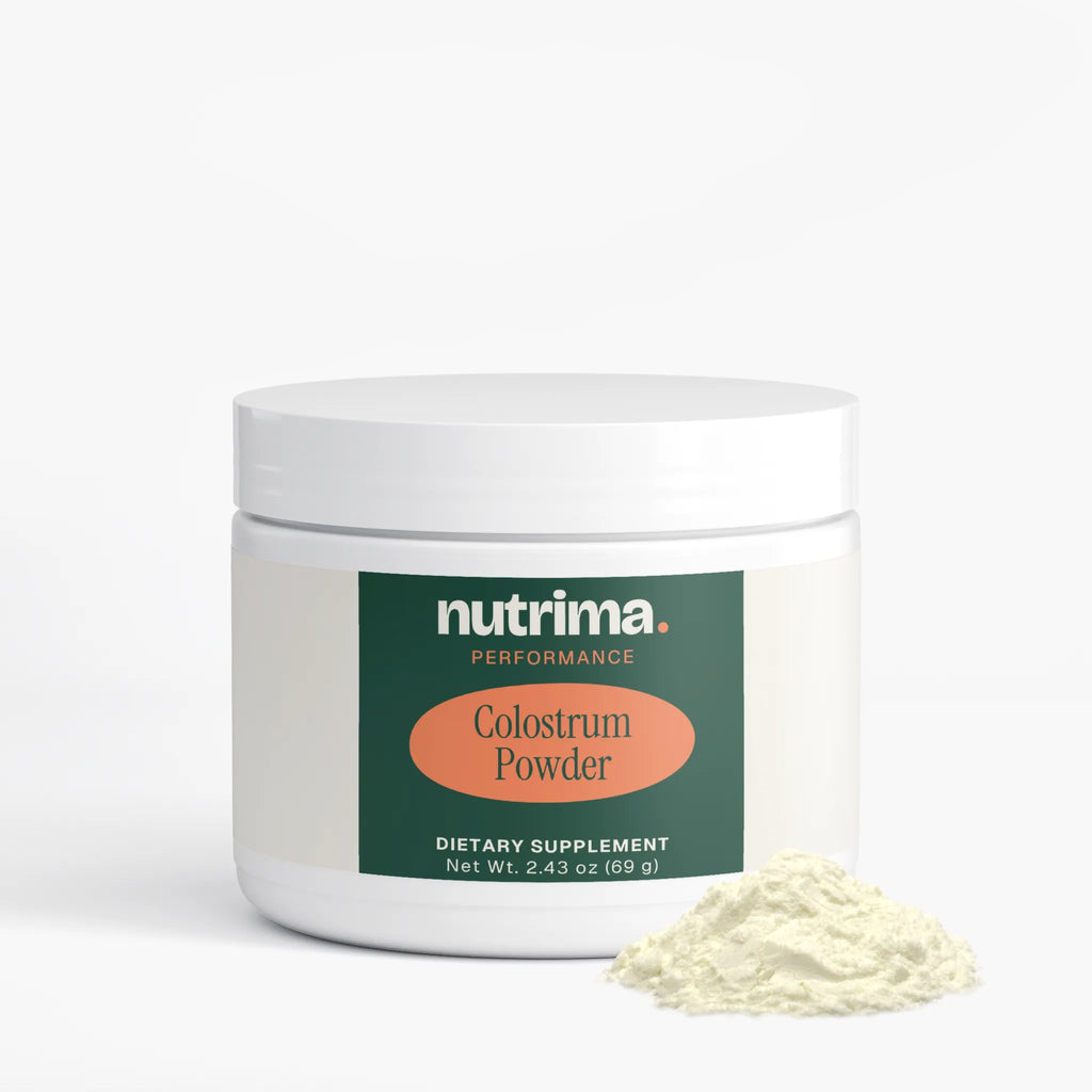 White jar of Colostrum Powder with a green label, accompanied by a scoop of powder, by nutrima.