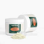 Colostrum Powder in a white container with a green label and a scoop.