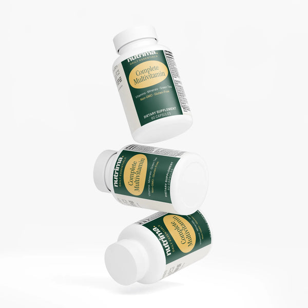 Three bottles of Complete Multivitamin, showcasing the green and cream label design, by nutrima.