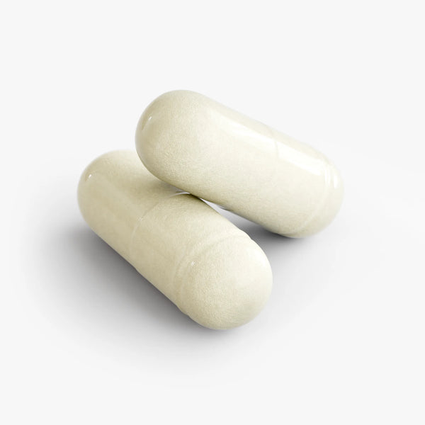 Two glossy cream capsules of Digestive Enzyme Pro Blend resting atop each other on a light background by nutrima.