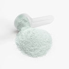 Light green Energy Powder (Melon Creamsicle) with a clear scoop, displayed in a pile on a white background by nutrima.