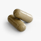 Two glossy brown capsules of Ginkgo Biloba + Ginseng stacked together on a white background by nutrima.