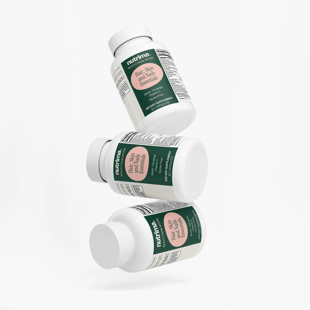 Three floating bottles of Hair, Skin and Nails Essentials by nutrima, showcasing a clean design and bright labels.