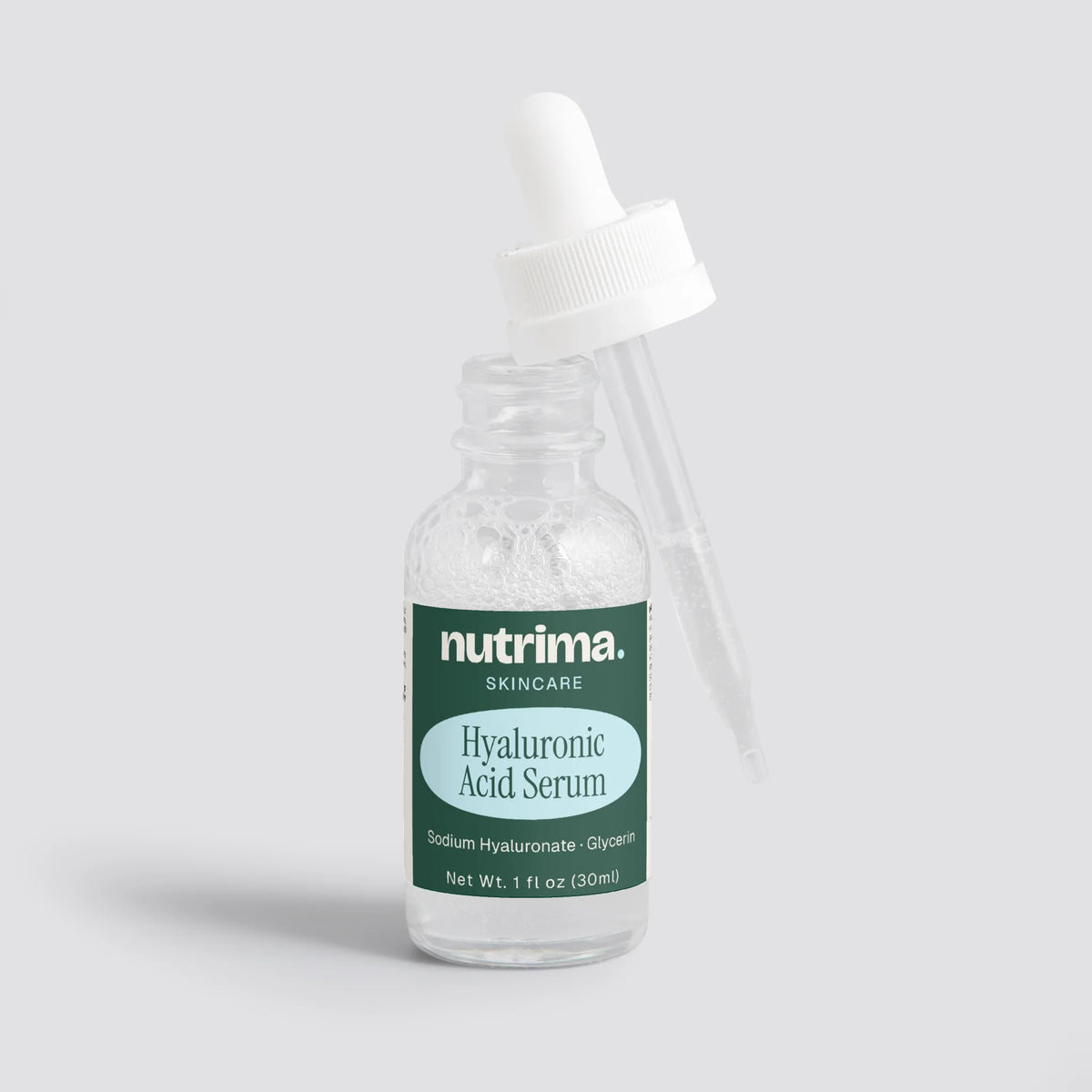 Clear bottle with dropper showcasing Hyaluronic Acid Serum, featuring a green label by nutrima.