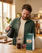 nutrima Deep Roast Coffee (Dark Roast) bag on a counter as a man pours hot water into a French press — AI-generated brand image