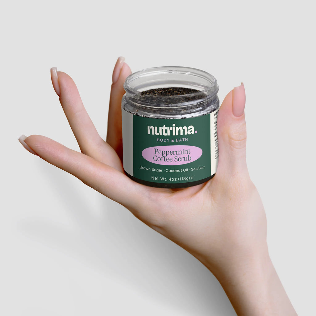 A hand holds the Peppermint Coffee Scrub jar, showcasing its unique blend of ingredients by nutrima.