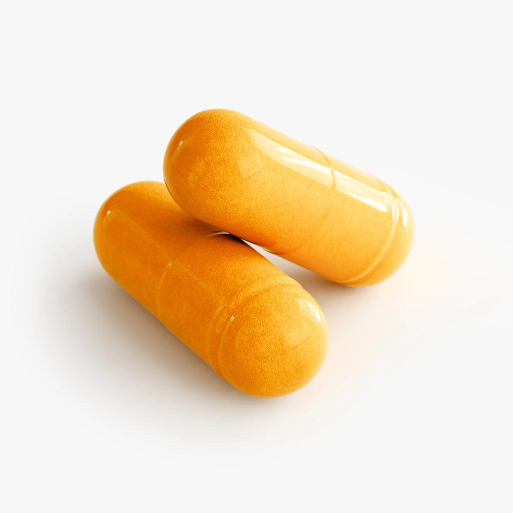 Two glossy yellow capsules of Platinum Turmeric, showcasing their vibrant color and smooth texture by nutrima.