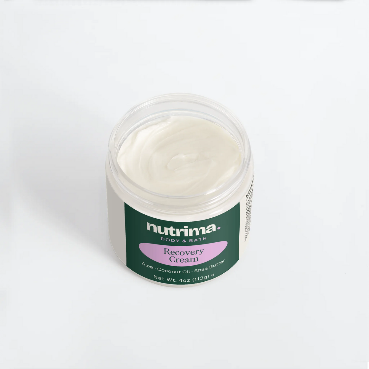 Top view of a jar of creamy white Recovery Cream with green and purple branding by nutrima.