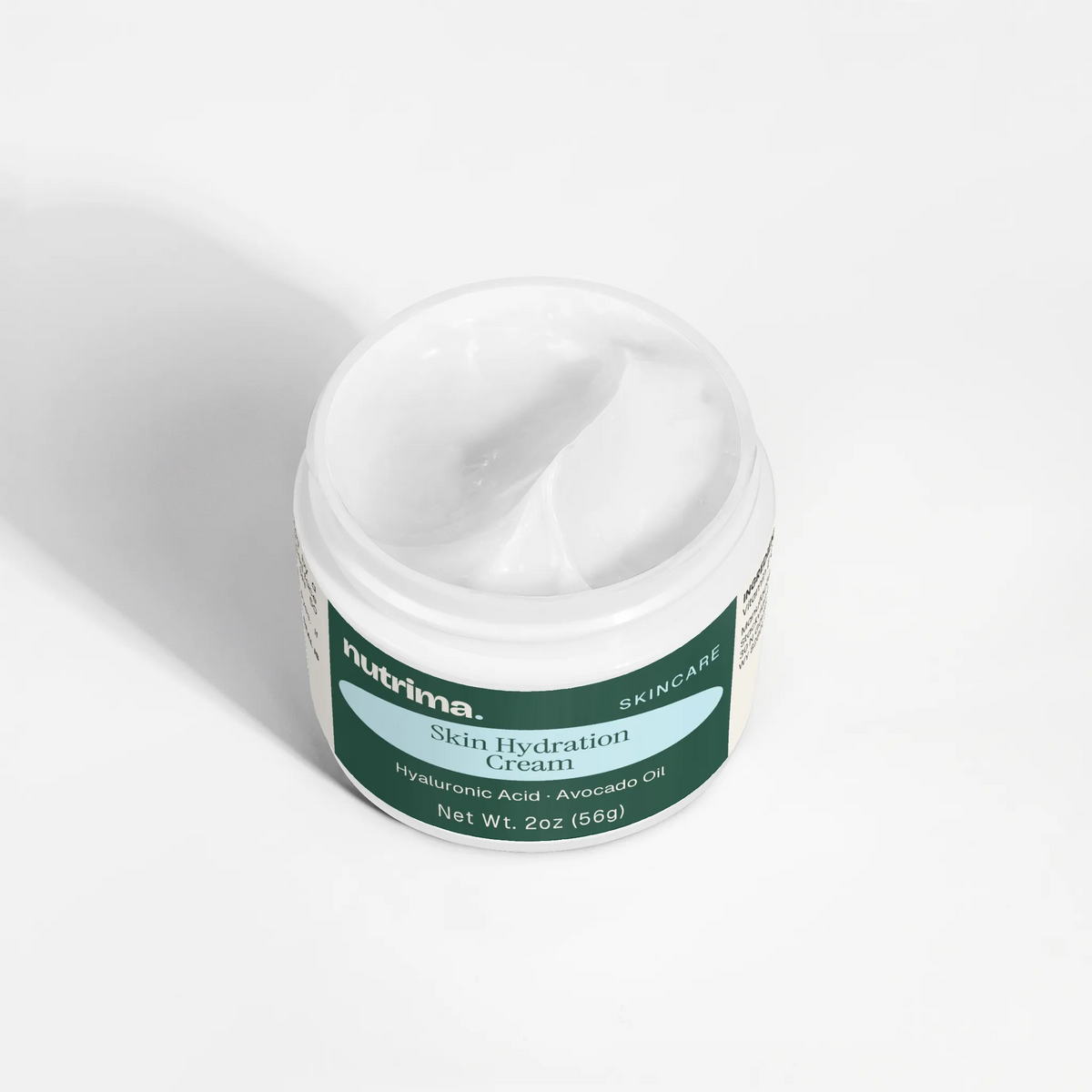 Close-up of the creamy texture in the open jar of Skin Hydration Cream by nutrima.